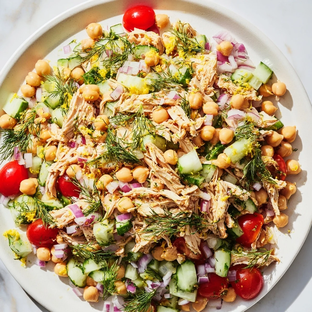 Freshly tossed dense bean salad with lemon-dill chicken, perfect for a flavorful, protein-packed lunch.