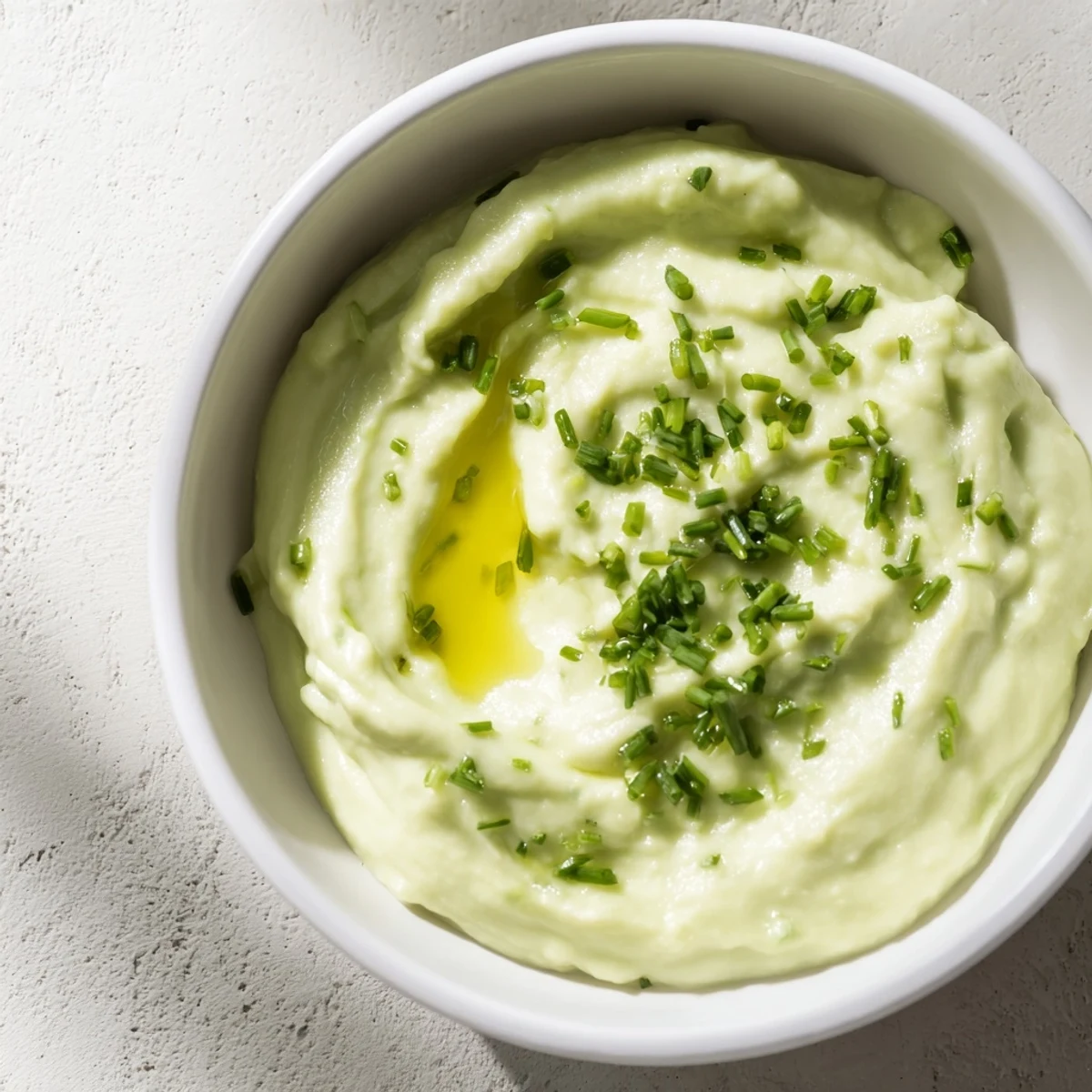 Enjoy a vibrant close-up of Avocado Cottage Cheese Dip, ready to be scooped up with fresh vegetables!