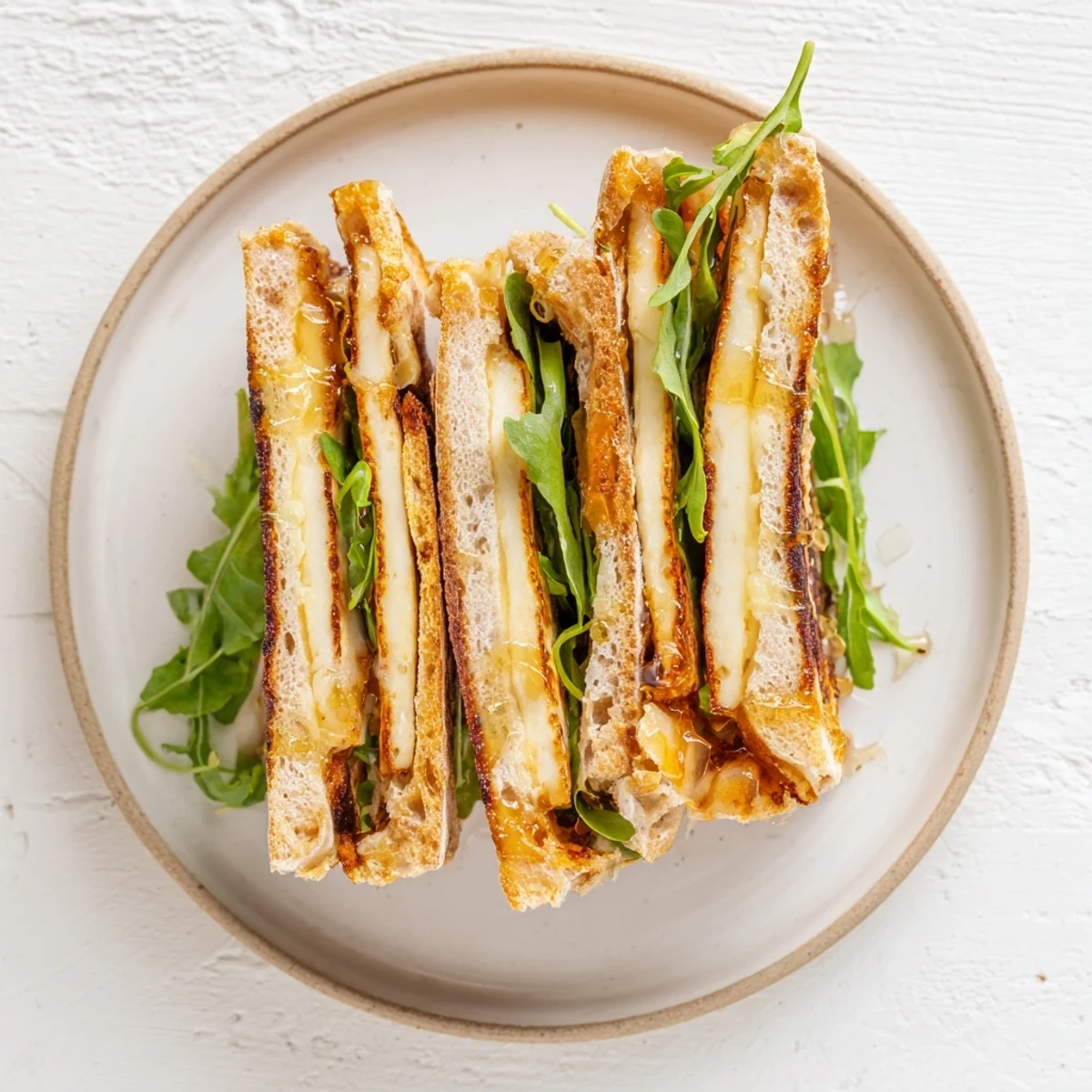 Enjoy the delicious textures: a toasted Crispy Halloumi Grilled Cheese, ready to serve with a simple side.
