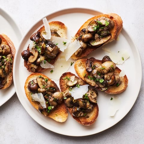 Crispy golden bread slices topped with savory mushroom bruschetta, ready for a delicious appetizer.