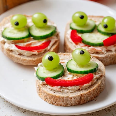 Adorable Prince Charming Froggy Sandwich cutouts, garnished with tomato cheeks and grape eyes, ready to eat!