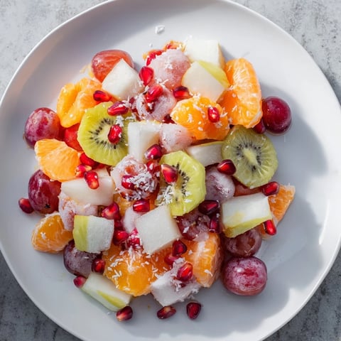 Vibrant Snowflake Fruit Medley, a refreshing winter salad with colorful fruits and a citrus dressing.