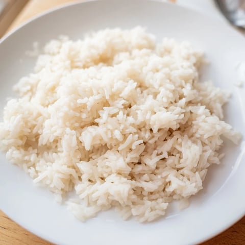 Fragrant Coconut Jasmine Rice, fluffy and aromatic, ready to serve alongside a vibrant Thai curry.