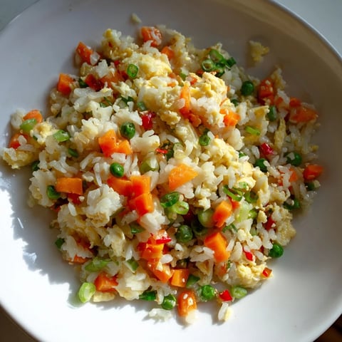 Fluffy egg fried rice with colorful vegetables, a quick and delicious weeknight dinner.