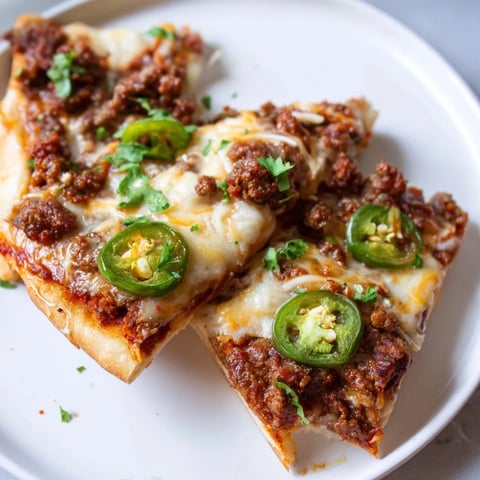 Fiery Spicy Ground Beef Pizza, overflowing with melted cheese, drizzled with hot honey.