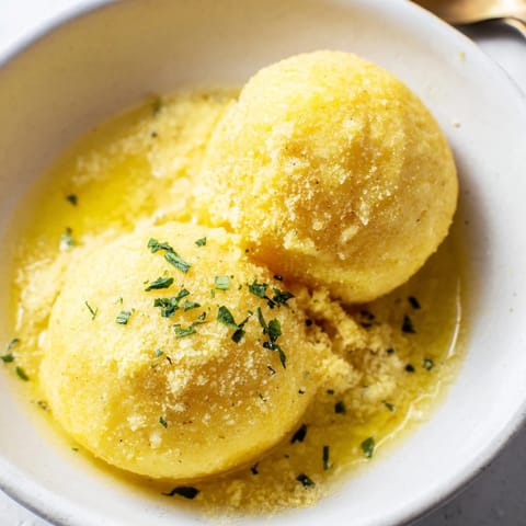 Golden, perfectly cooked potato dumplings, a delightful and filling vegetarian meal option.