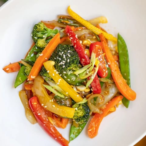 Steaming vegetable stir-fry with sesame seeds, a quick and easy colorful meal using frozen veggies.