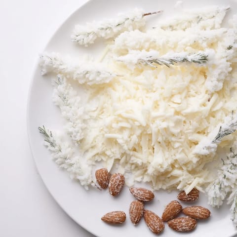 Close-up of The Frosted Pine: a winter cheese platter with sugared rosemary and almond pinecones.