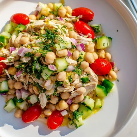 Bright, colorful close-up of dense bean salad with lemon-dill chicken, ready to be enjoyed.