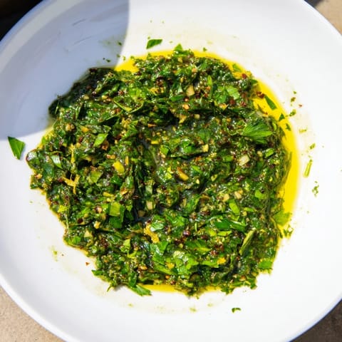A close-up of vibrant Moroccan Chermoula Marinade, showcasing fresh cilantro and lemon zest before marinating.
