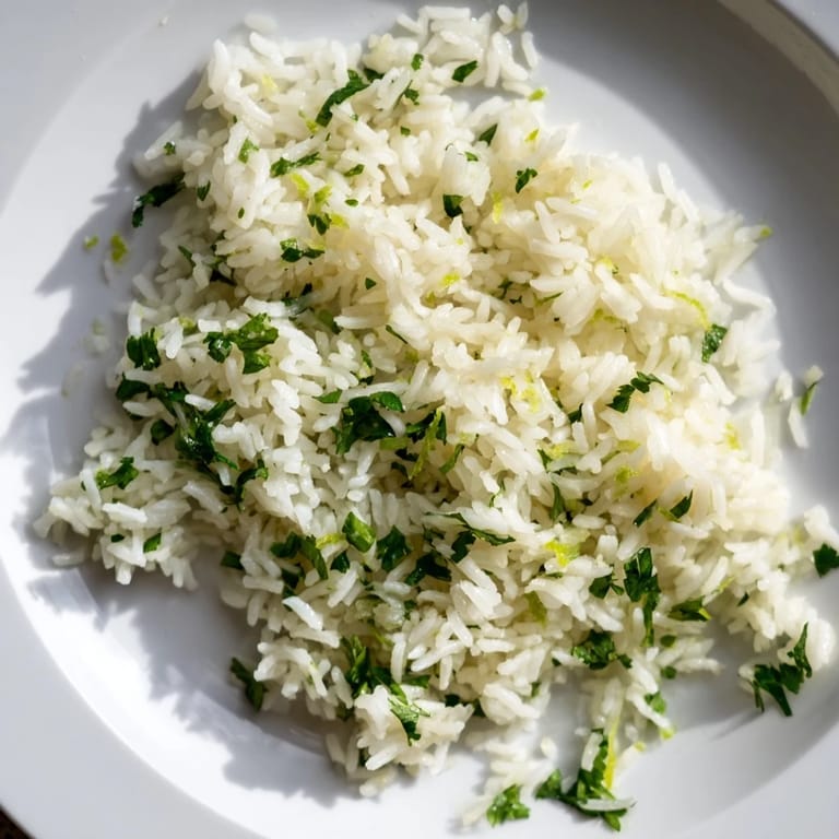 Steaming bowl of cilantro lime rice, perfect side for tacos, infused with lime zest.